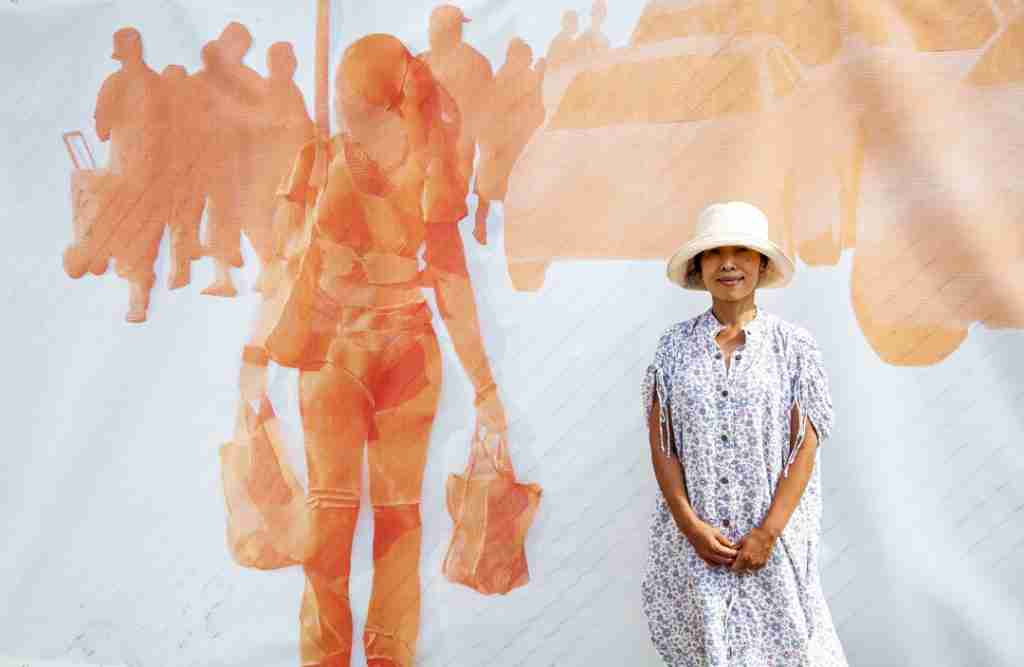 Woman standing in front of outdoor art work