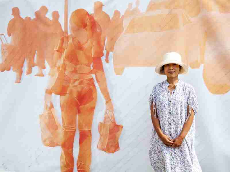 Woman standing in front of outdoor art work