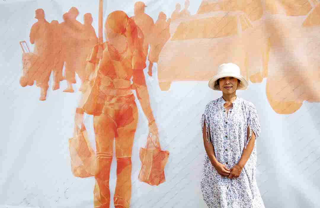 Woman standing in front of outdoor art work
