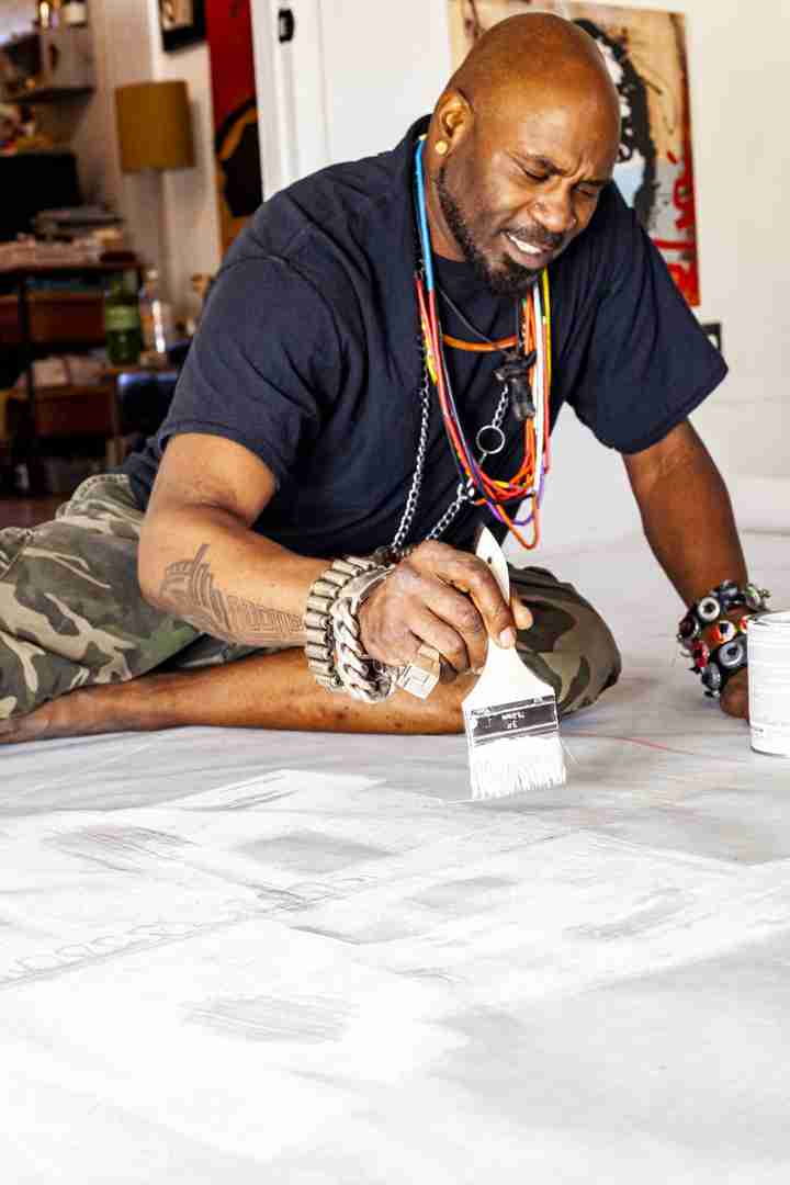 Voodo Fé painting his mural SOAR